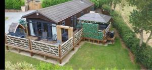 an overhead view of a house with a large deck at Peaceful Holiday Lodge with Hot Tub in Lincolnshire