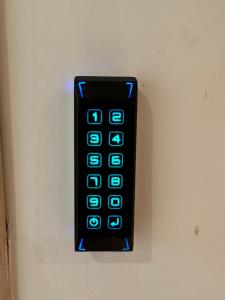 un mando a distancia negro colgando de una pared en ComfortHouse LaVilla, en Ladispoli