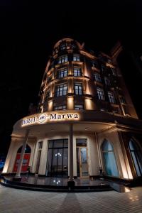 a building with a sign on the front of it at Hotel Marwa Tashkent Pool&Spa in Tashkent