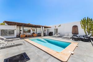 a villa with a swimming pool and a patio at Villa Patos in Playa Blanca