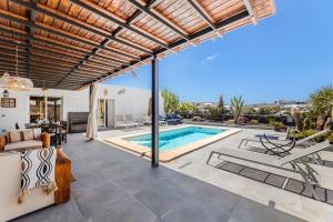 a villa with a swimming pool and a patio at Villa Patos in Playa Blanca