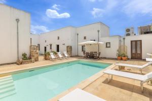 a swimming pool in the backyard of a house at Luxury Courtyard in Racale