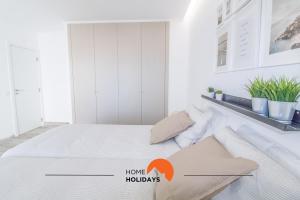 a bedroom with a bed with the words home hollidays at #048 Sea and City view with Pool, AC in Brejos