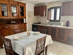 a kitchen with a table with a white table cloth at Housalento in Francavilla Fontana
