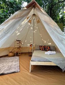 a tent with a bed in the middle of a room at Habitat Eco Farm in Sorrento