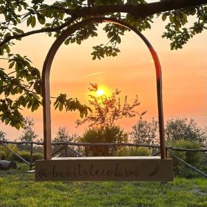 an archway with the sunset in the background at Habitat Eco Farm in Sorrento