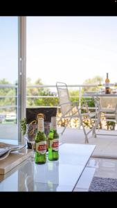 two bottles of beer sitting on top of a table at Luxury Holiday Home Albufeira in Albufeira