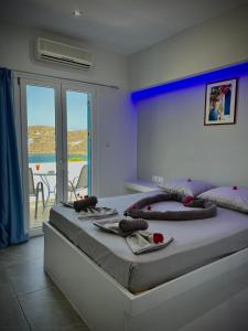 a bedroom with a large bed with towels on it at Princess Sissy in Ios Chora