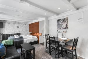 a hotel room with a bed and a table and chairs at Baron Downtown Apartments in Reykjavík