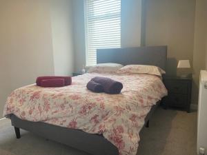 a bedroom with a bed with two pillows on it at Private double room in our Cardiff Home in Cardiff