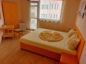 a bedroom with a bed with an open window at Primorski Briz Guest House in Primorsko