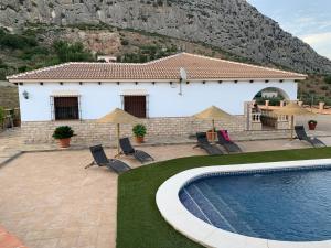 a house with a swimming pool in front of a house at Casa de María in Valle de Abdalagís