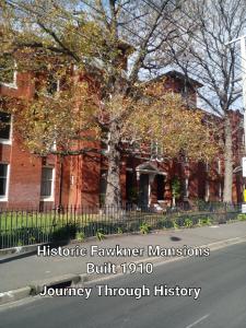 a red brick building with a tree in front of it at Fawkner Mansions Heritage Hotel in Melbourne