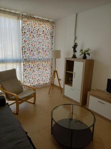 a living room with a couch and a glass table at Apartamento El Ingenio in Adra