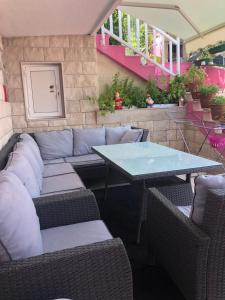 Lilac Apartments في تروغير: فناء مع طاولة وأريكة وطاولة