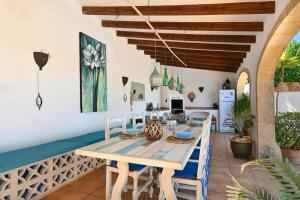a dining room with a wooden table and chairs at Casa Que Sera in Jávea
