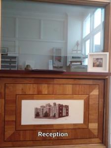 a display case with a picture of a building at Fawkner Mansions Heritage Hotel in Melbourne