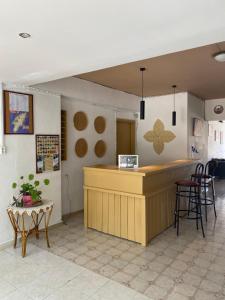 a bar in a restaurant with a counter and chairs at Ikaros Studios in Faliraki