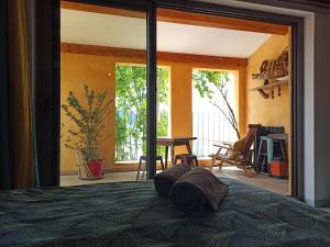 a bedroom with a bed and a sliding glass door at Ô Rêves Ailleurs in Saint-Cyr-sur-Mer
