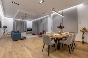 a dining room with a table and chairs and a couch at Armonia Luxury Villa in Ialysos