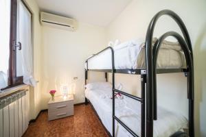 a bedroom with two bunk beds and a window at Gardappartamenti Sorgente Pool in Sirmione