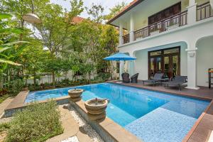 a swimming pool in the backyard of a house at Luxury Danatrip Villas in Danang