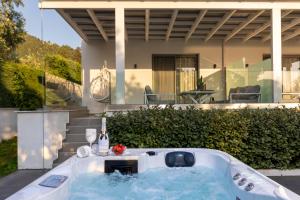 a bath tub in front of a house at Pachis Escape Suites in Pachis