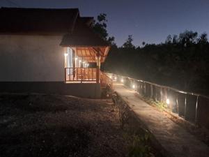 a building with lights on the side of it at night at Vina Bungalow in Toyapakeh