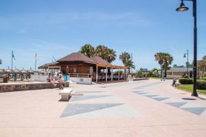 a park with a pavilion and people sitting on benches at JAZMÍN 24 in Torremolinos