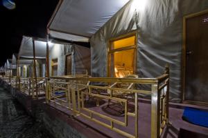 a row of chairs in a tent at night at Pangong Retreat Camp in Spangmik