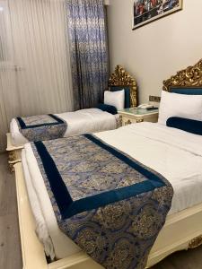 two beds in a room with blue and white at İstasyon Hotel in Istanbul