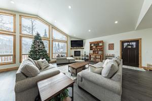 a living room with two couches and a christmas tree at Bears Den in Brian Head