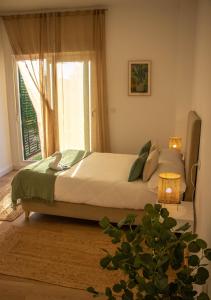 a bedroom with a large bed with a window at CostaSerenaSuites in Nigrán