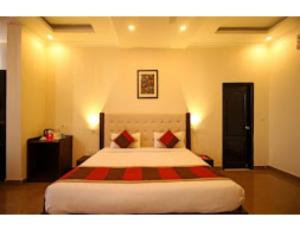 Shiva Farm, Hotel Baramasa By Welinna Group, Dehradun في دهرادون: غرفة نوم بسرير كبير في غرفة