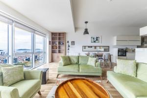 a living room with two couches and a table at Sea View New Built Residence Near Kartal Coast in Istanbul
