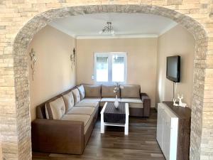 a living room with a couch and a tv at Apartments Neira near Dubrovnik in Ivanica