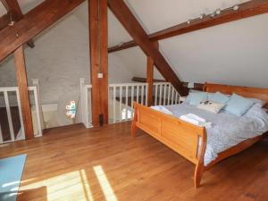 a bedroom with a bed in a attic at Chapel House in Llangollen