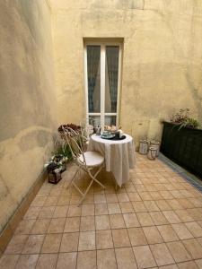 a table and a chair on a patio at Vetus Auximon in Osimo