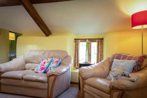 a living room with a couch and a chair at The Snickett in Combe Martin