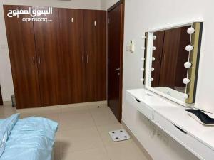 a bathroom with a mirror and a counter with a sink at One Bed Room Apartment Muscat Hills in Muscat