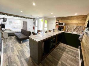 a kitchen and living room with a couch and a bed at Willow Inn in Kent