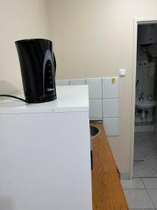 a microwave sitting on top of a white counter at U Marty in Jaworzno