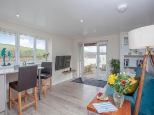 a living room with a kitchen and a dining room at Riverside Apartment in Bideford