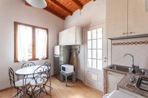 a kitchen with a table and a refrigerator at Casa liberty style in Milan
