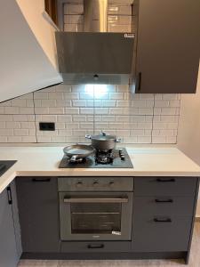 - une cuisine avec 2 casseroles et des poêles sur une cuisinière dans l'établissement KARAASLAN GROUP TATİL EVLERİ, à Kusadası