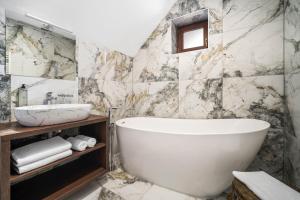 a bathroom with a tub and a sink at Hotel MAXPLAZA in Trnava