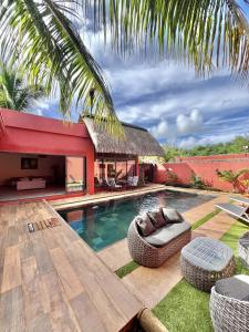 a backyard with a swimming pool and a house at Villa Raphaël in Pointe aux Piments