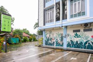 a building with a mural on the side of it at Urbanview Hotel Double Tree Purwokerto by RedDoorz in Purwokerto