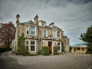 a large brick house with a large driveway at Tali Ayer in Nairn
