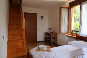 a bedroom with a bed and a staircase and a stair case at Villa Luzzago in Ponte di Legno